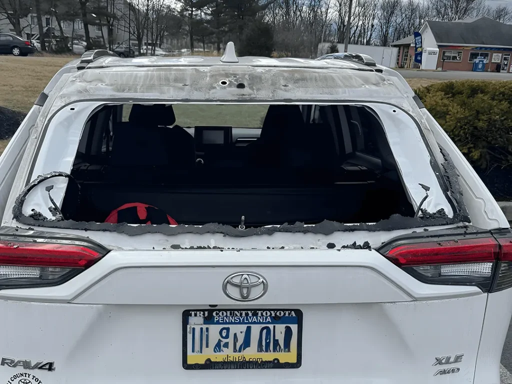 white toyota with broken back glass