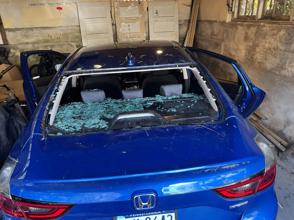 blue honda with broken back glass